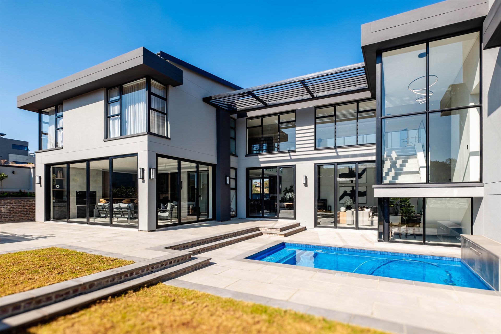 TMG Designs aluminium sliding doors on a modern home with a pool